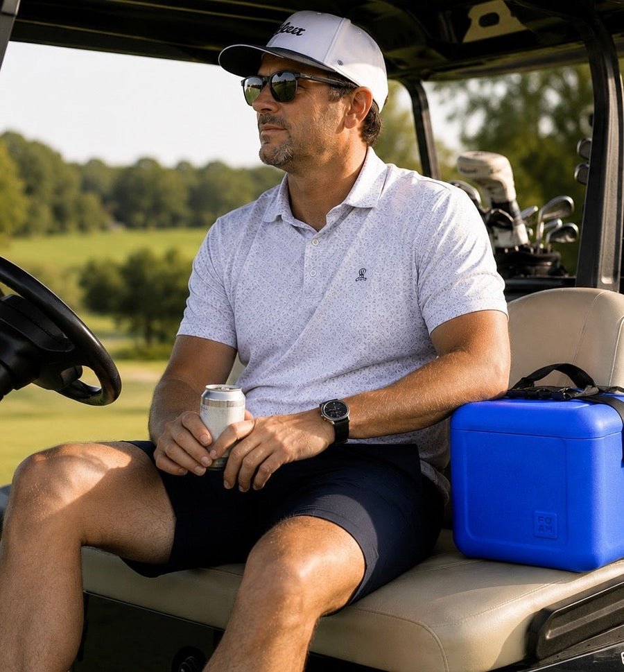 Dad in golf cart with FOAM cooler.